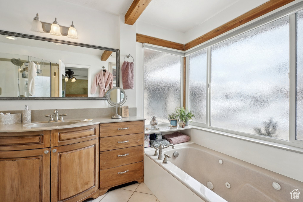 Full bath featuring tile patterned floors, vanity, a whirlpool tub, and beamed ceiling