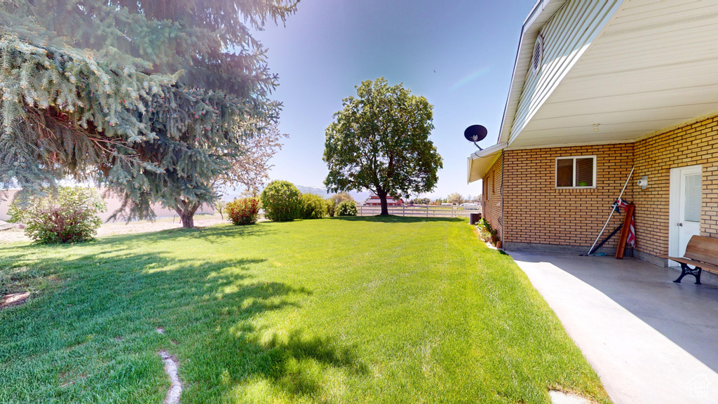 View of yard with a patio area and fence