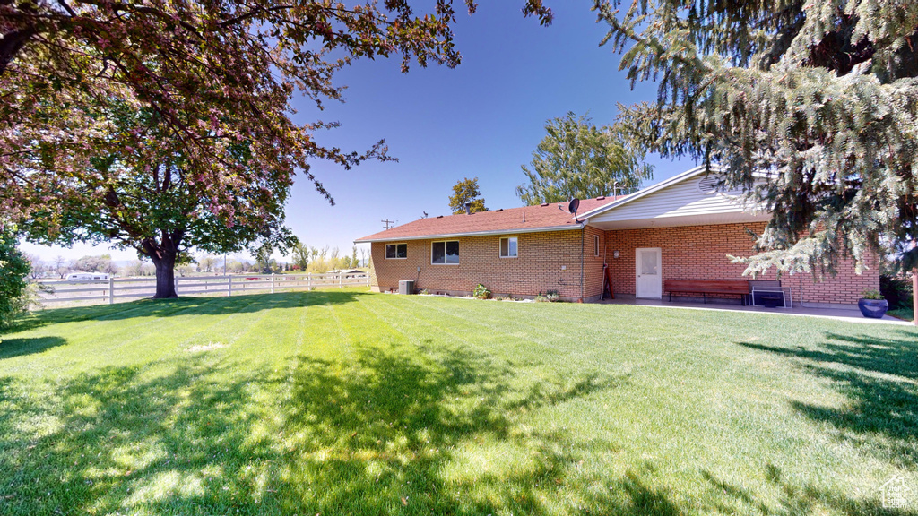 View of yard with a patio area and fence