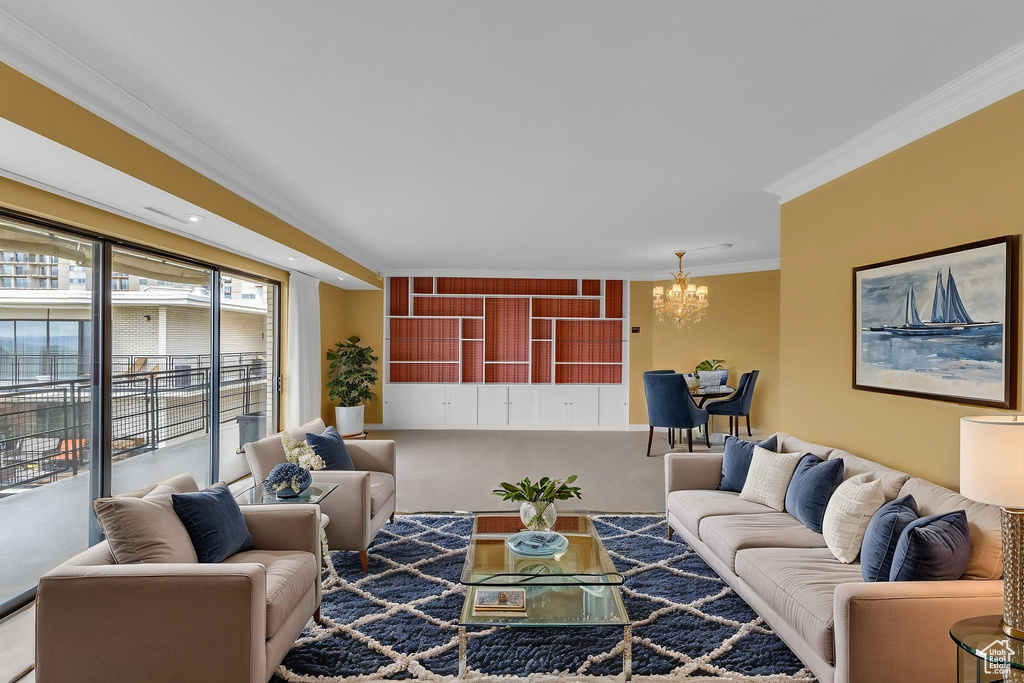 Living area with crown molding and a chandelier