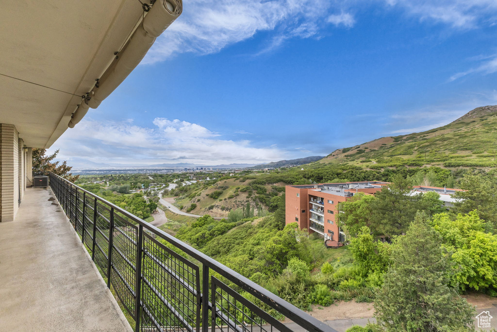 Balcony featuring a mountain view and cooling unit