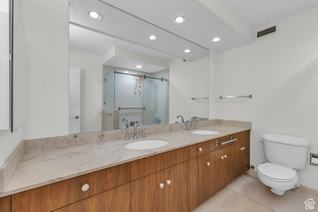 Full bath featuring a stall shower, toilet, vanity, recessed lighting, and tile patterned flooring