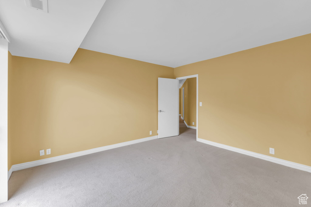 Unfurnished room featuring baseboards and carpet