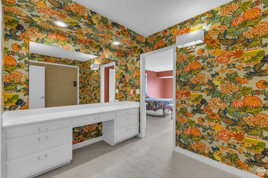 Ensuite bathroom with wallpapered walls and vanity