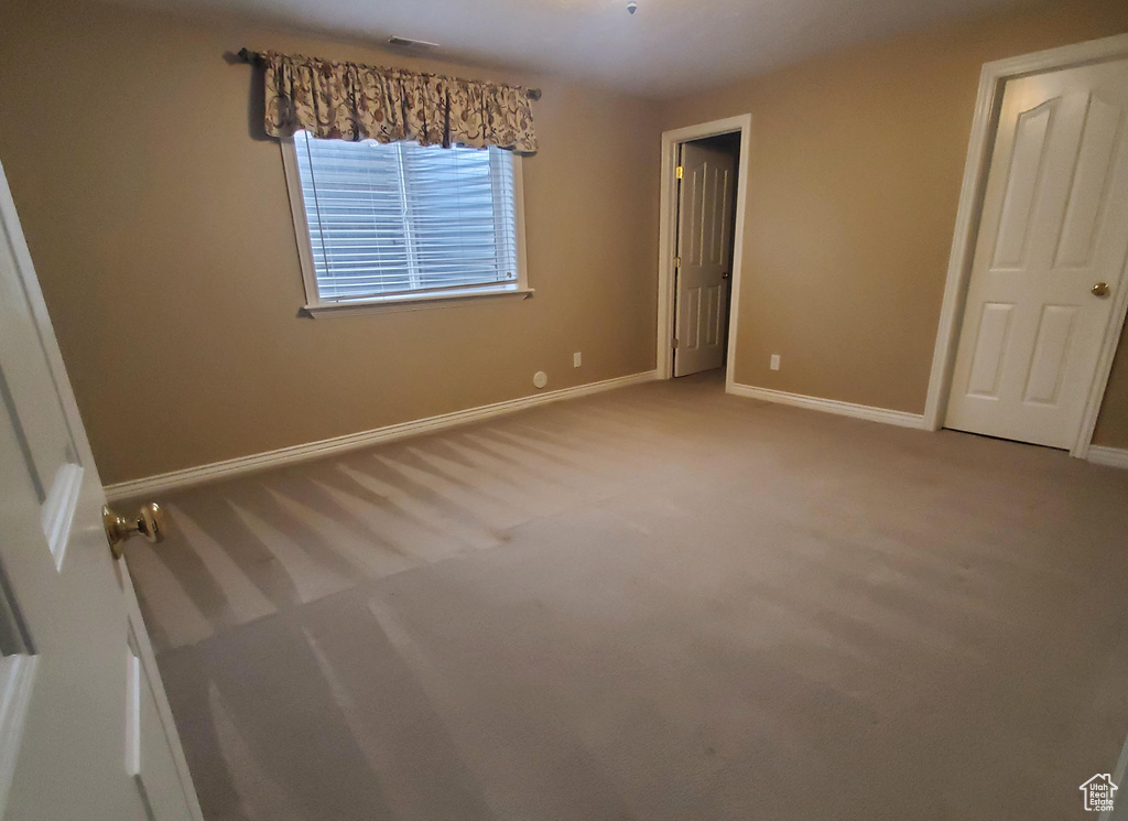 Unfurnished bedroom with baseboards and carpet