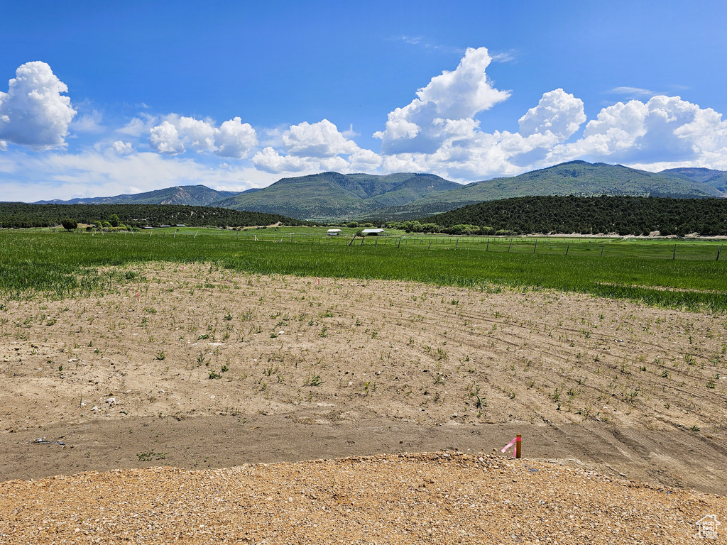 View of mountain backdrop with rural landscape