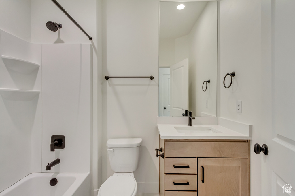 Full bathroom featuring bathtub / shower combination, vanity, and toilet