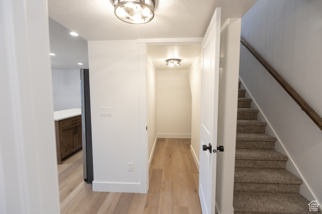 Stairs with recessed lighting, baseboards, and wood finished floors