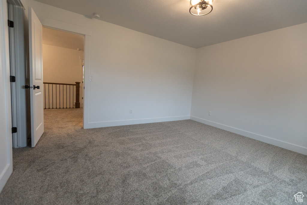 Carpeted empty room featuring baseboards