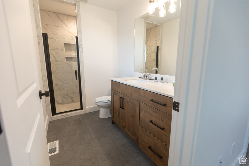 Full bathroom featuring vanity, visible vents, a marble finish shower, tile patterned flooring, and toilet