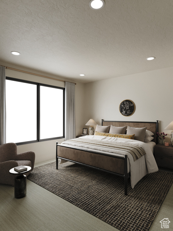 Carpeted bedroom with recessed lighting and a textured ceiling