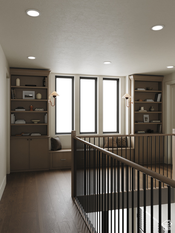 Hall featuring hardwood / wood-style flooring, recessed lighting, and an upstairs landing