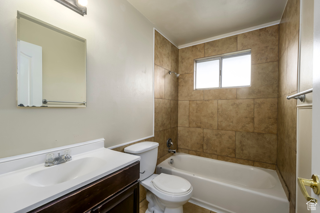 Full bath with vanity, toilet, and washtub / shower combination