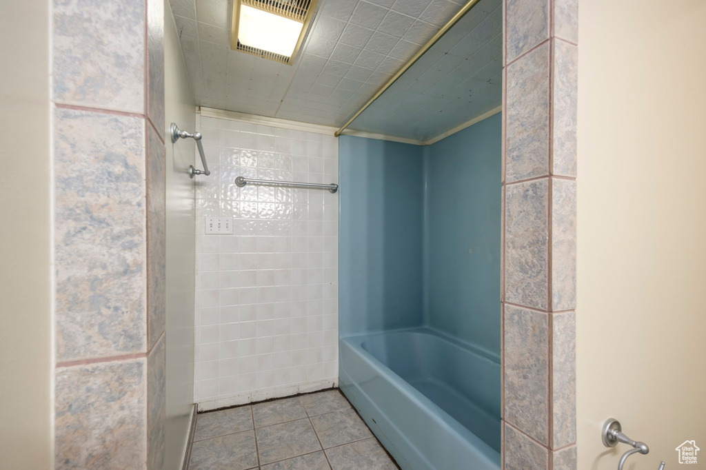 Full bath with tile patterned flooring and shower / bathing tub combination