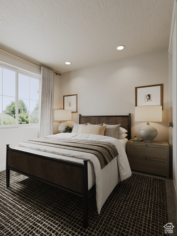 Carpeted bedroom with a textured ceiling and recessed lighting