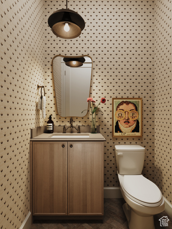 Bathroom with vanity and wallpapered walls