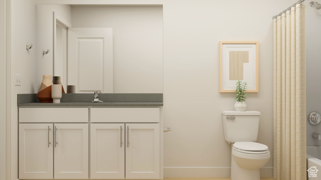 Full bath with toilet, vanity, and baseboards