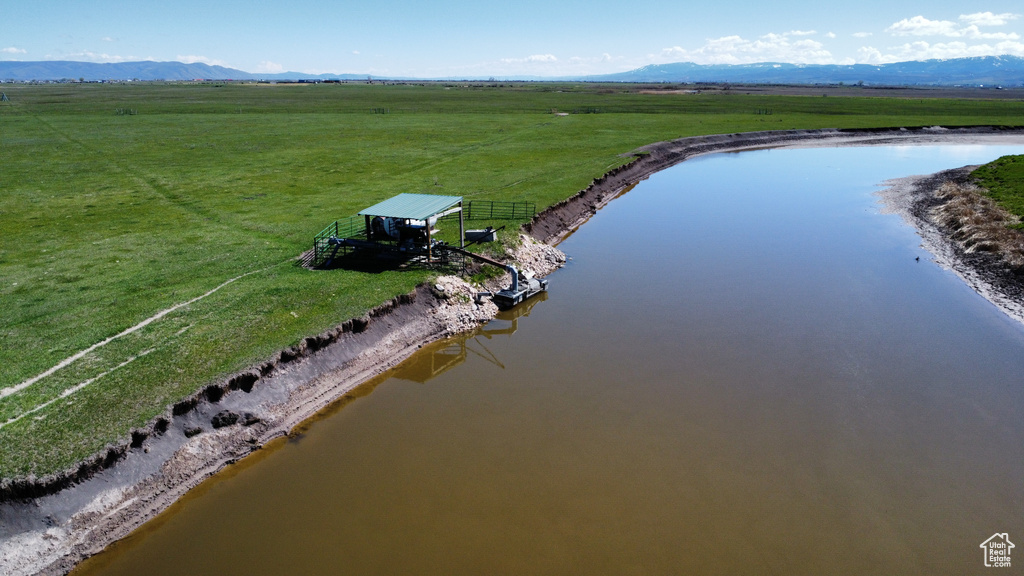 Overview of rural landscape featuring a water and mountain view