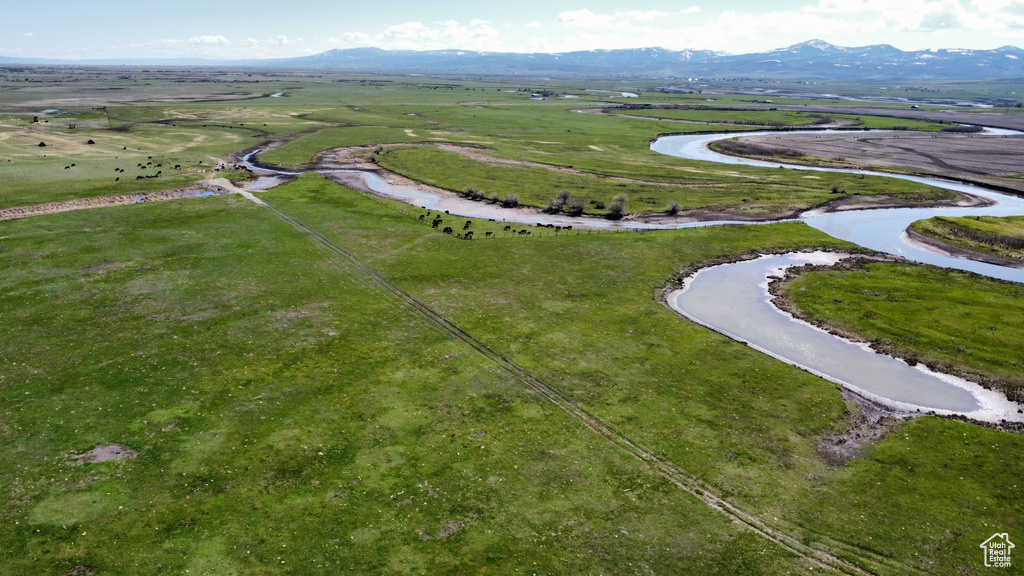 Aerial view of property and surrounding area with a mountainous background and rural landscape