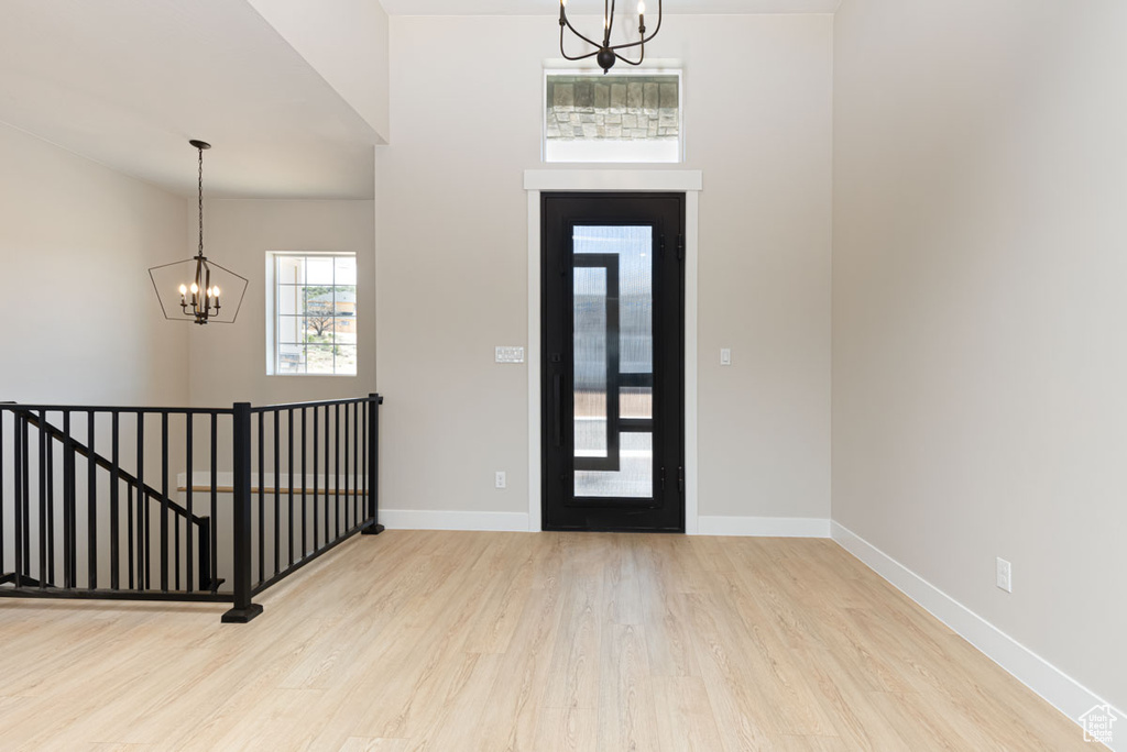 Entrance foyer with a chandelier and wood finished floors