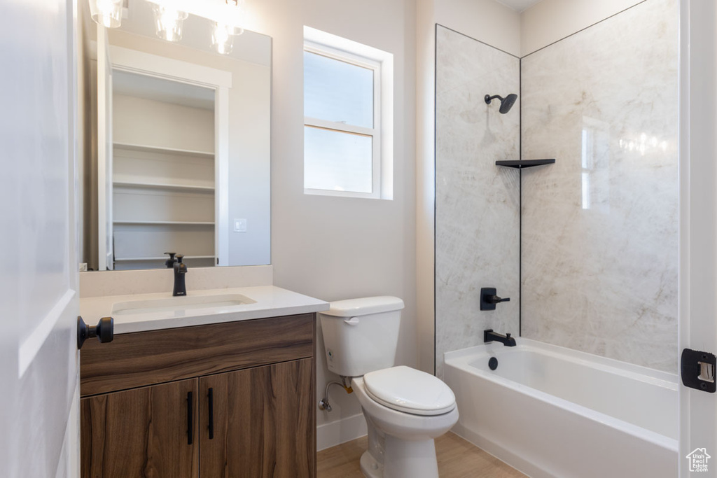 Bathroom featuring vanity and washtub / shower combination