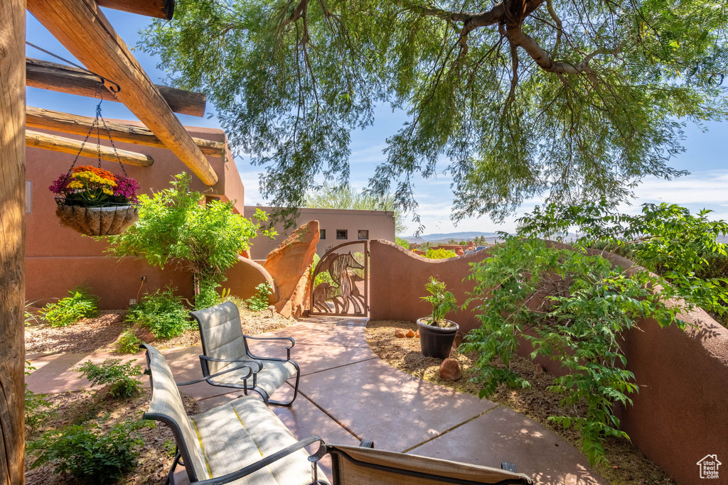 View of patio featuring a gate
