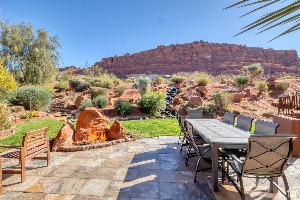 View of patio / terrace featuring outdoor dining space and a mountain view
