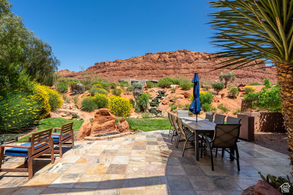 View of patio / terrace featuring outdoor dining area and a mountain view