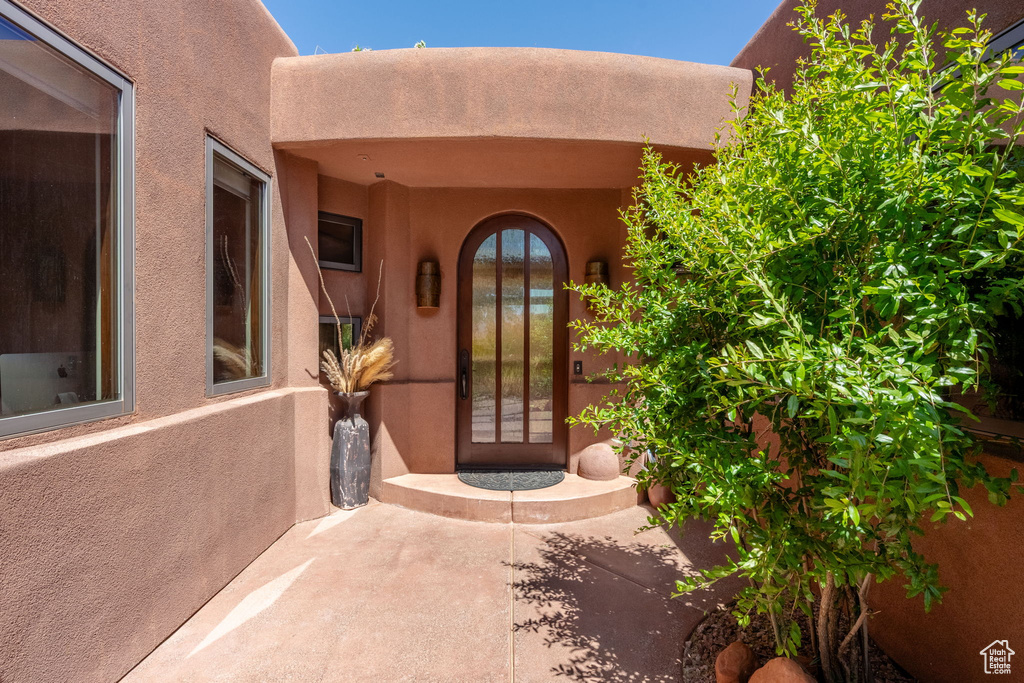 Entrance to property with stucco siding