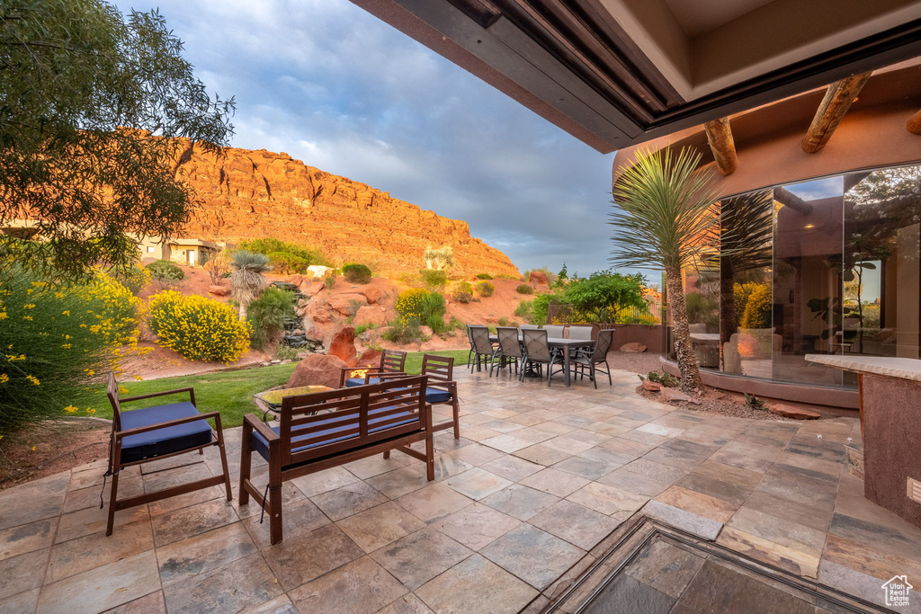 View of patio / terrace featuring outdoor dining area, a mountain view, and an outdoor hangout area