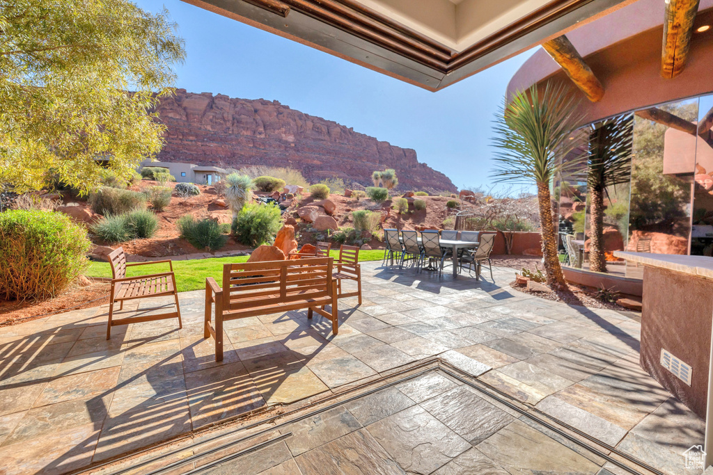 View of patio featuring outdoor dining space, an outdoor living space, and a mountain view