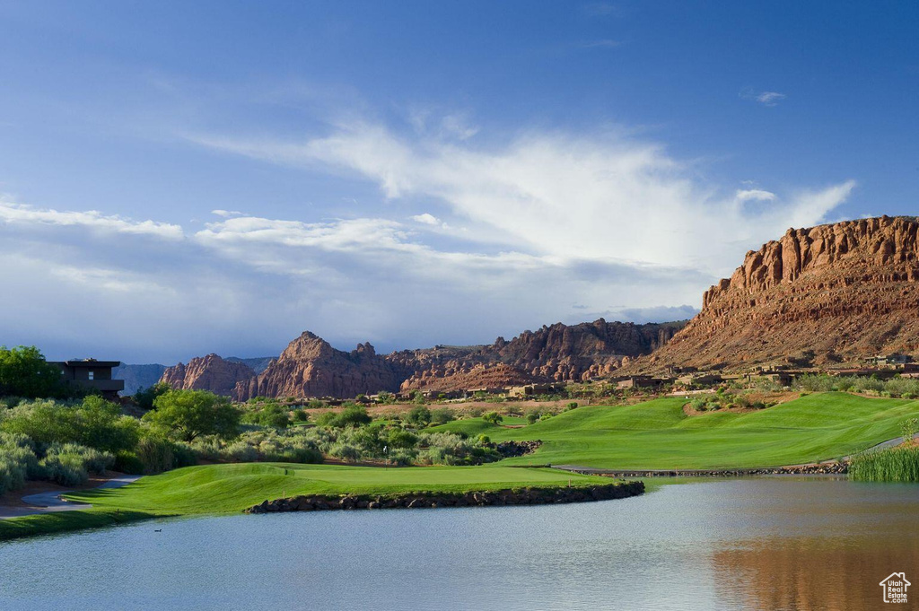 Water view featuring a golf club and mountains