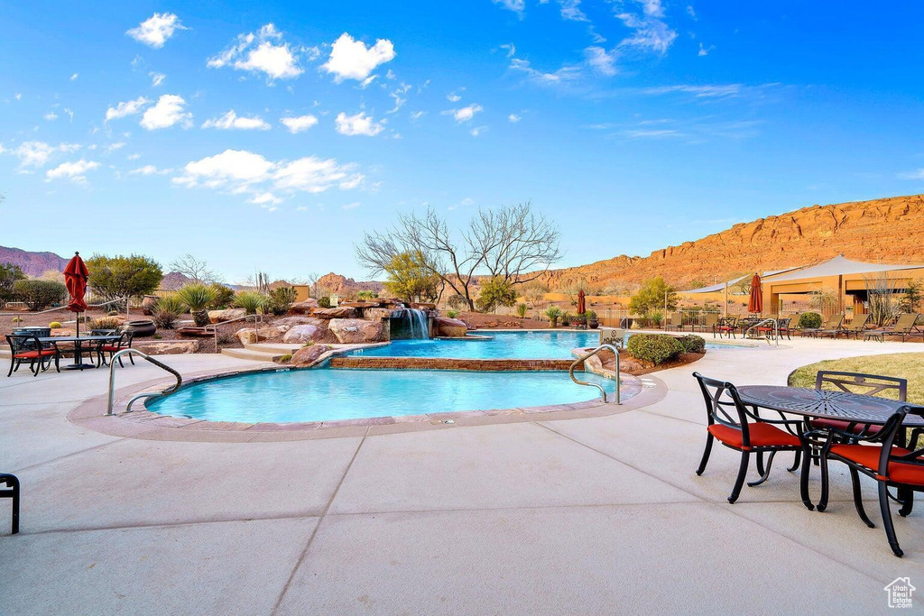 Community pool with a mountain view and a patio