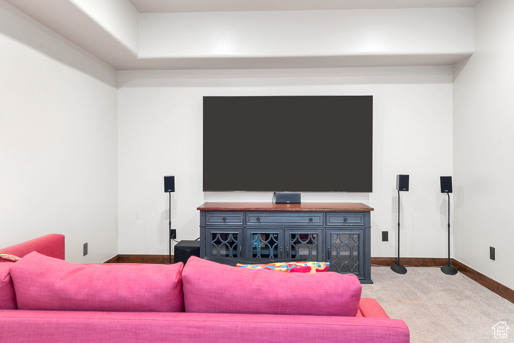 Living area featuring baseboards and carpet