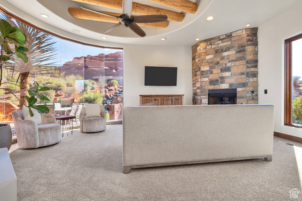 Living room featuring recessed lighting, carpet floors, a stone fireplace, and a healthy amount of sunlight