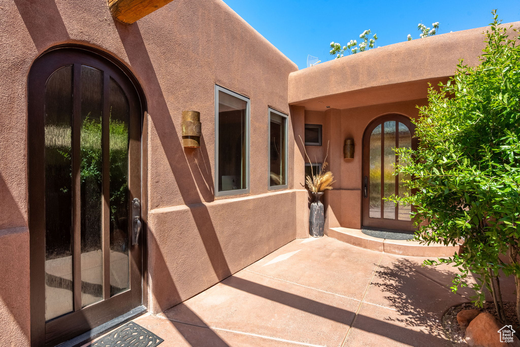 Property entrance featuring stucco siding