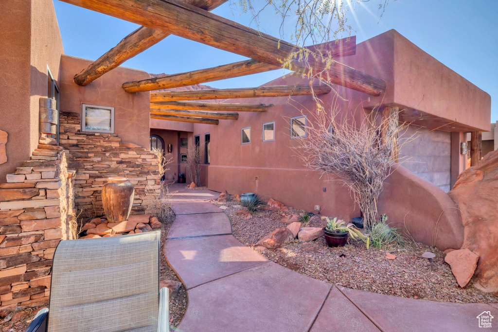 Property entrance with a patio area