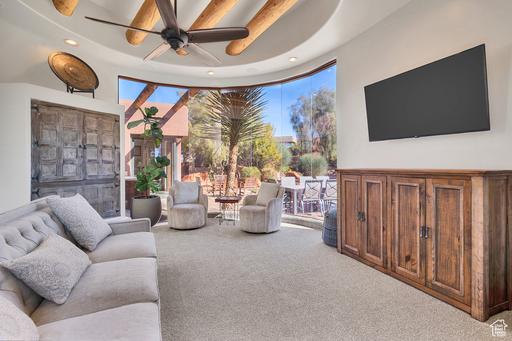 Carpeted living area with recessed lighting and a ceiling fan