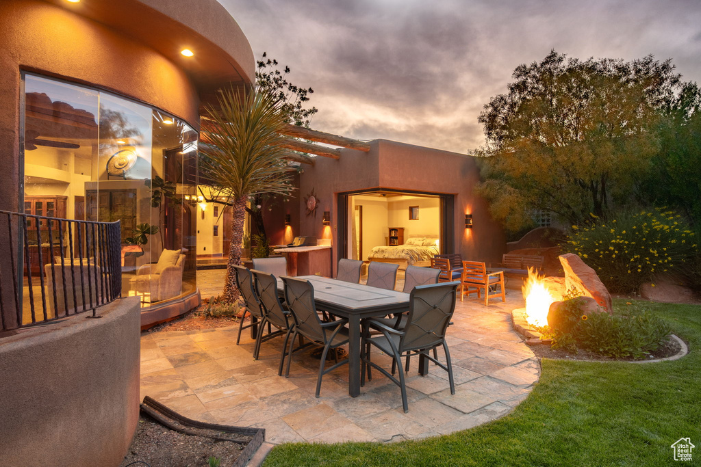 View of patio with an outdoor fire pit and outdoor dining space