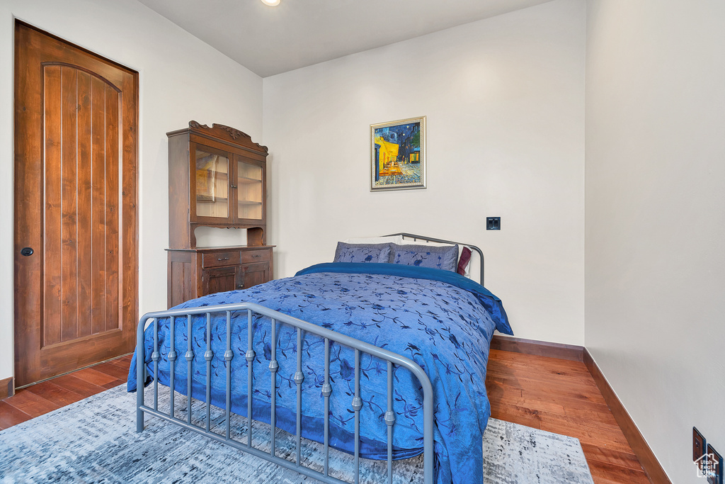 Bedroom featuring wood finished floors and baseboards