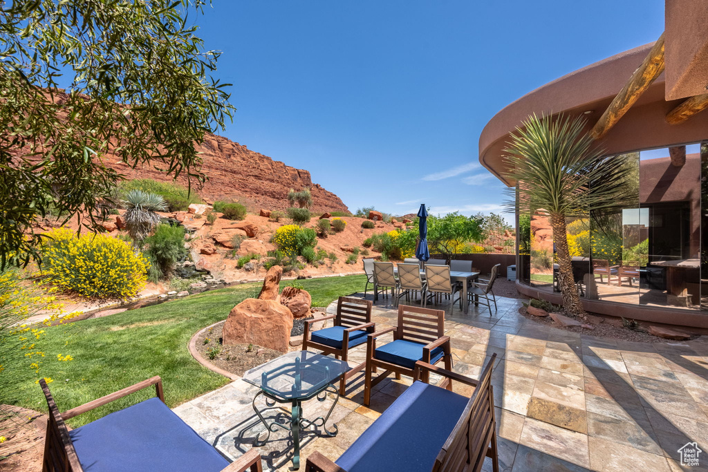 View of patio featuring outdoor dining area, outdoor lounge area, and a deck with mountain view