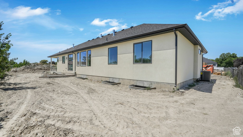 Back of property with a shingled roof