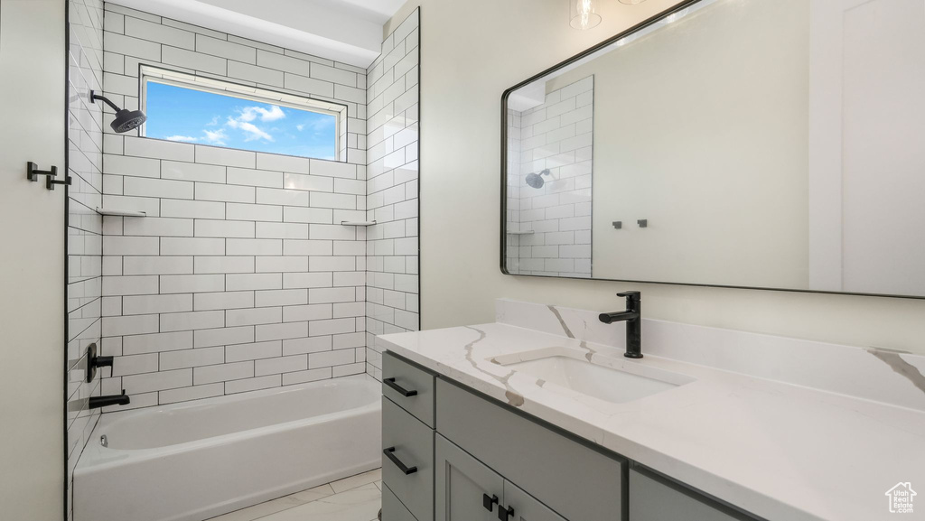 Full bathroom with vanity, shower / bath combination, and marble finish floors