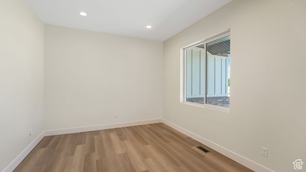 Unfurnished room with light wood-style floors and recessed lighting