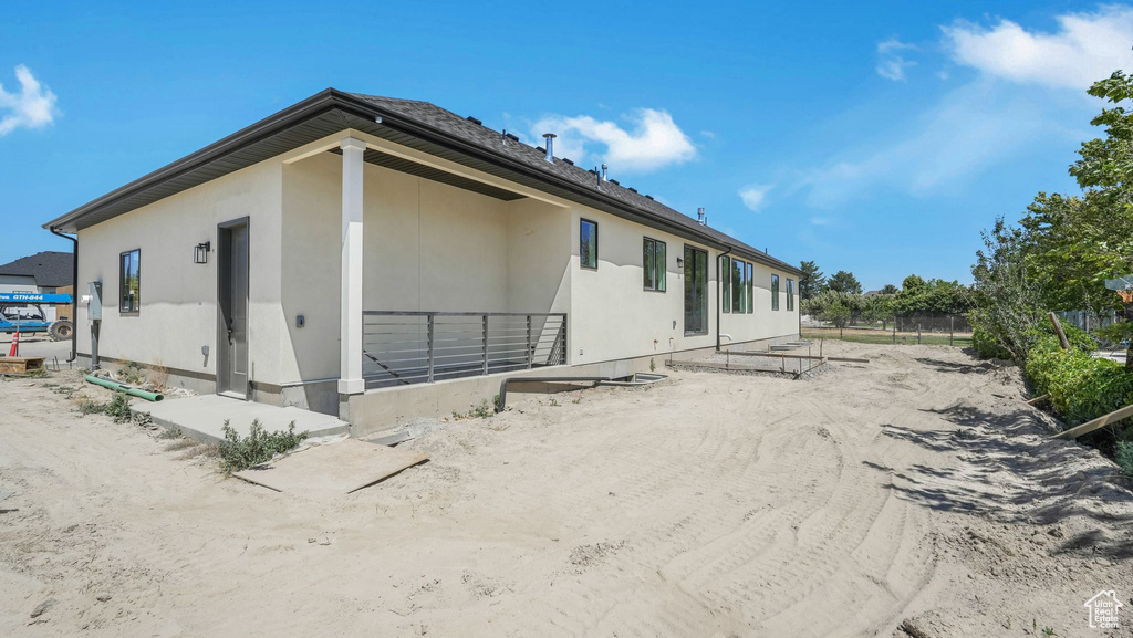 Back of property featuring stucco siding