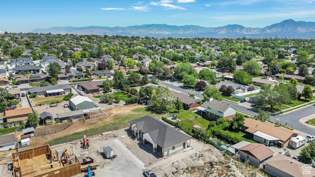 Aerial view of residential area featuring a mountainous background