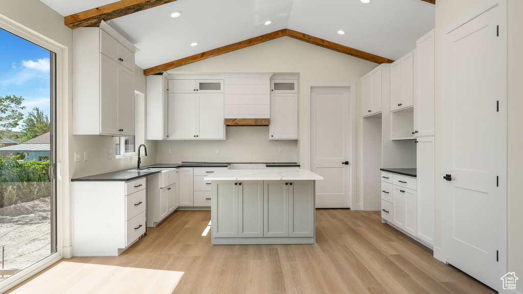 Kitchen featuring plenty of natural light, light wood-type flooring, white cabinets, and recessed lighting