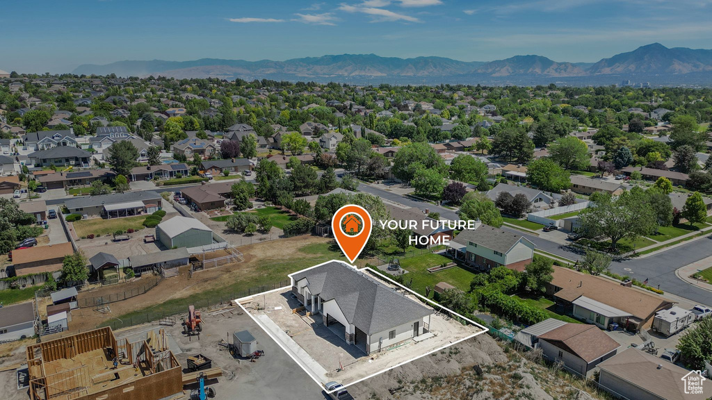 Aerial view of residential area featuring a mountainous background