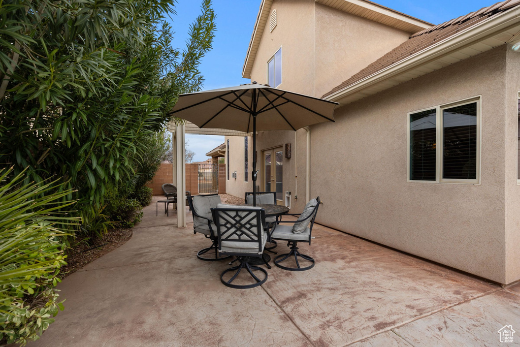 View of patio featuring outdoor dining area and fence