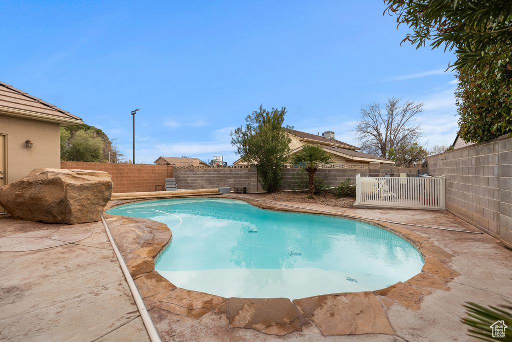 View of swimming pool featuring a patio area, a fenced in pool, and a fenced backyard